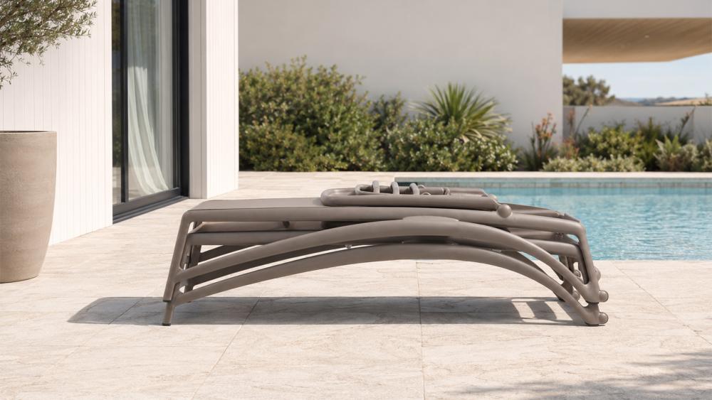 Nardi Atlantico sun lounger in taupe positioned beside a residential pool