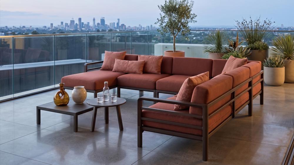 Modular outdoor lounge setup on a large apartment terrace with city views