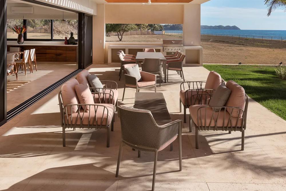 Outdoor space divided into a dining zone and a shaded lounge zone