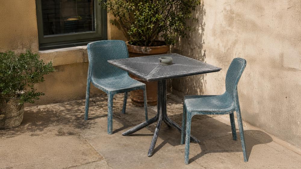 Faded and cracked cheap plastic chair showing UV damage after sun exposure