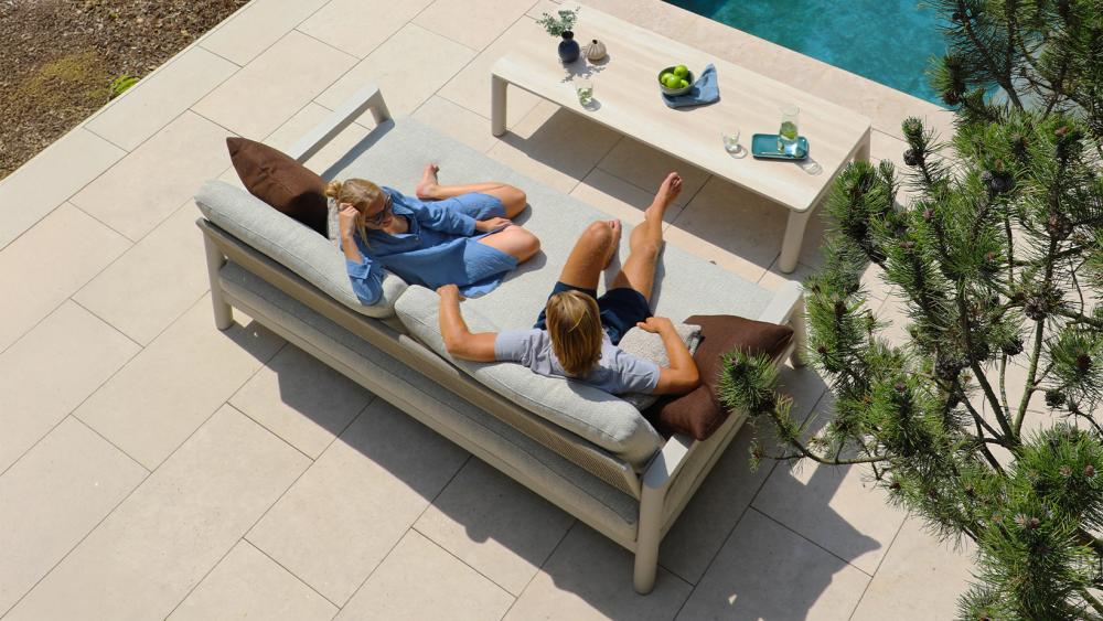Pebl Tolo 3-seater aluminium outdoor sofa in charcoal with taupe cushions on a covered patio
