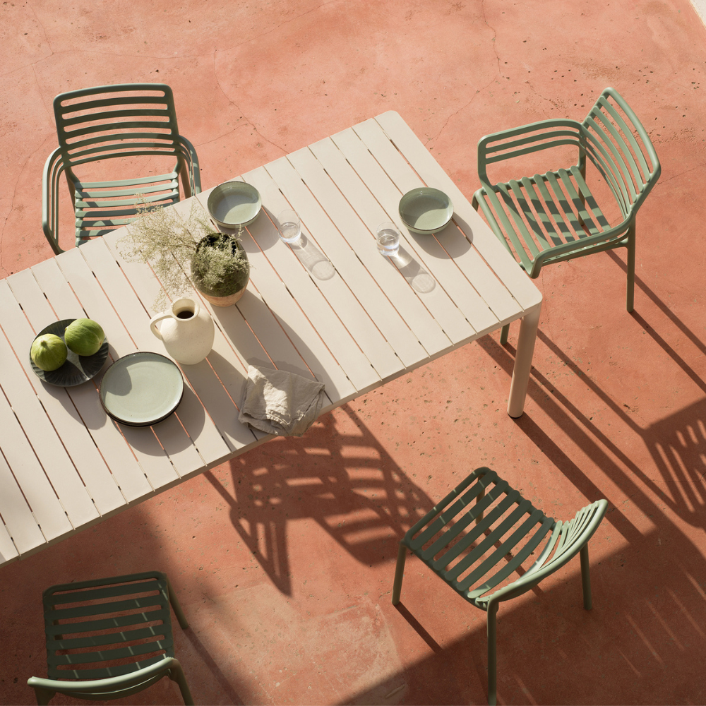 Nardi Doga resin armchairs around an outdoor table on a terracotta terrace, seen from above